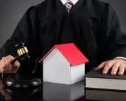 Judge Holding Gavel With House Model